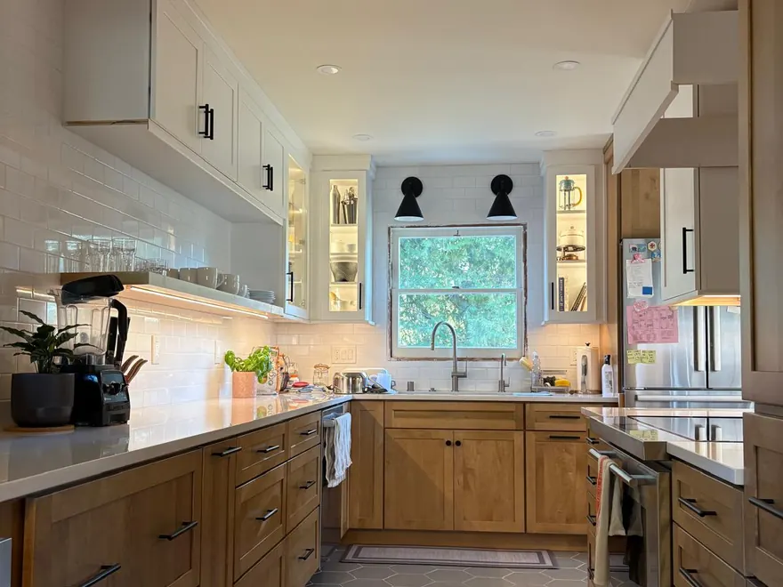 Renovated kitchen with oak cabinetry and stone counters
